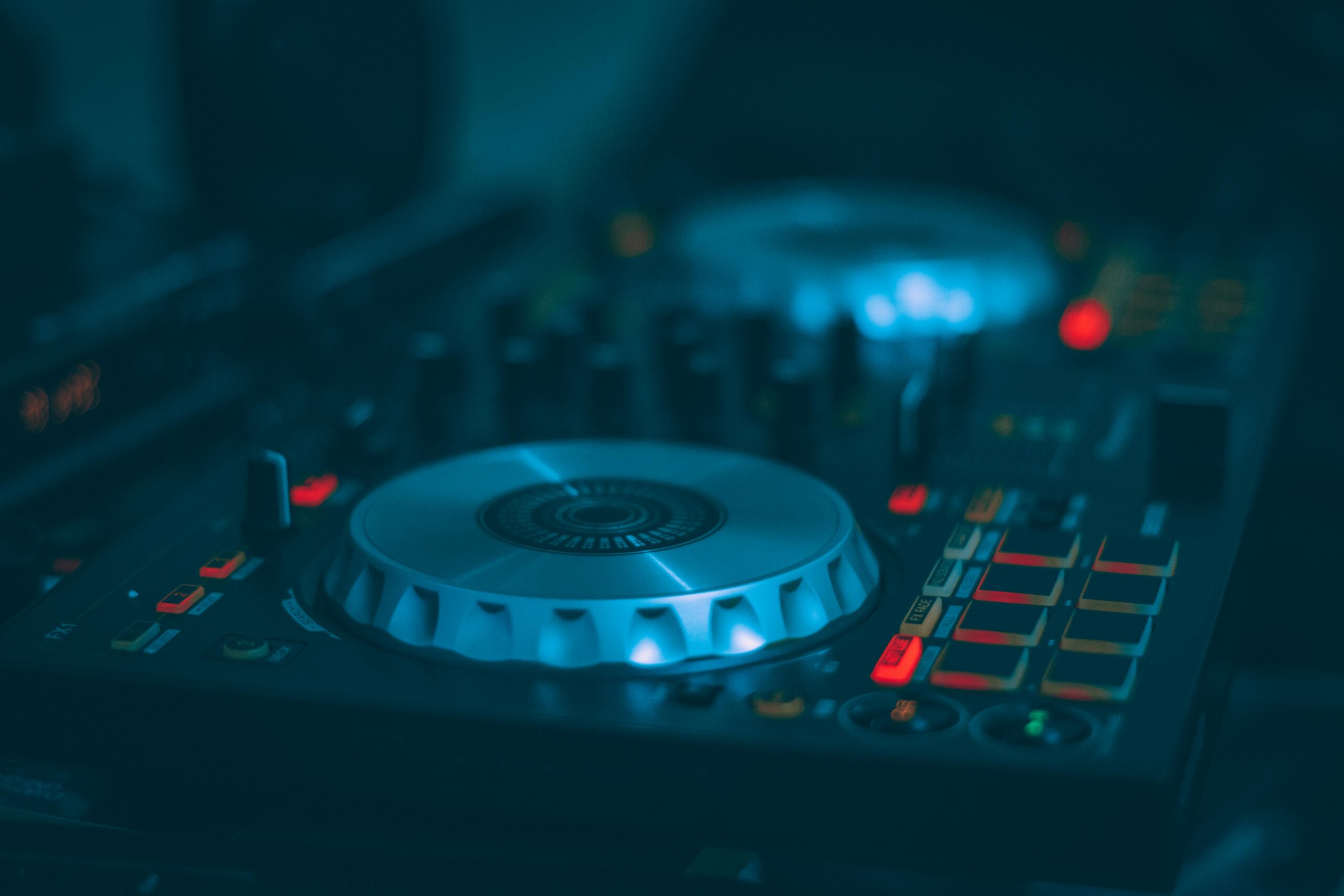 A detailed shot of a DJ mixer with illuminated buttons and controls, ideal for music and technology themes.